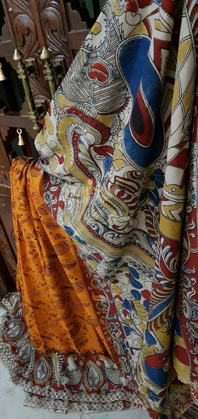 Squash orange silk kalamkari with intricate peacock motif on pallu and border and musical instruments all over the saree .