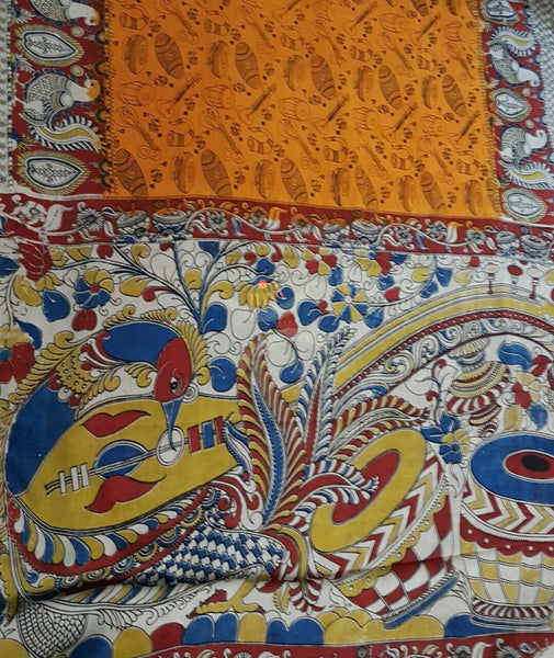 Squash orange silk kalamkari with intricate peacock motif on pallu and border and musical instruments all over the saree .
