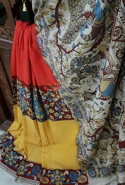 Red yellow chennur silk kalamkari with intricate peacock motif and Radha Krishna motif on pallu and on border.