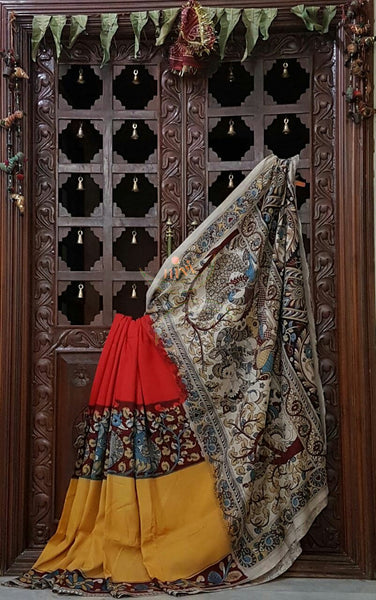 Red yellow chennur silk kalamkari with intricate peacock motif and Radha Krishna motif on pallu and on border.