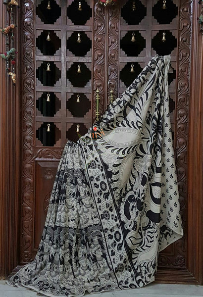 Black and white chennur silk kalamkari with intricate peacock, gowmata  and floral motif on pallu and on border.