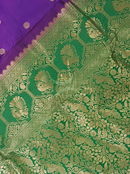Purple silk Paithani with traditional peocock motif comes with contrasting Green border and pallu.