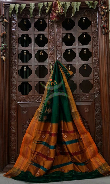 Green with mustard silk cotton kasuti embroidered Ilkal with Anne ambari motif and traditional tope teni pallu . 