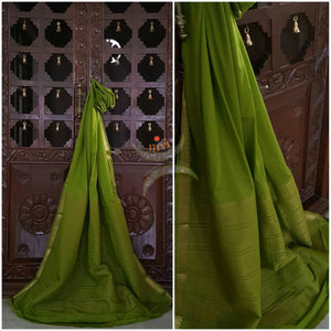 Green Art silk crepe with woven zari border and striped zari woven lines.
