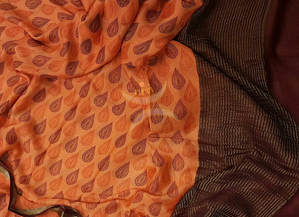 Orange 40 gram Chinon Printed crepe pure silk with contrasting Brown zari border.