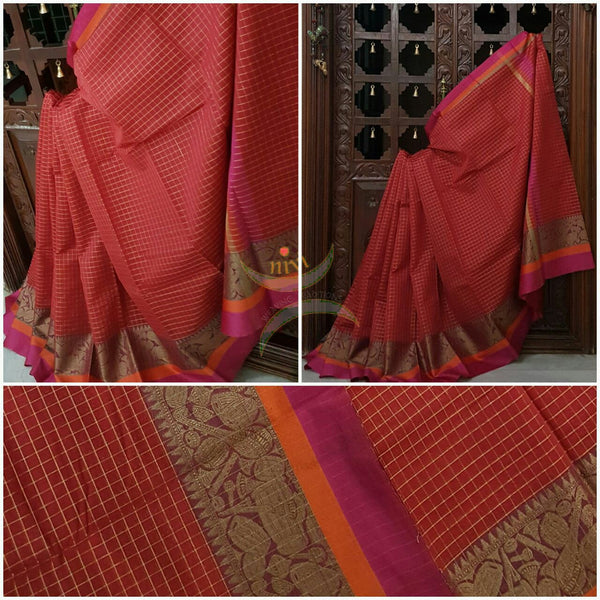 Red Silk Cotton chequered saree with satin finish contrasting pink orange border and woven musical instruments at border with antique gold zari. Saree comes with running blouse.