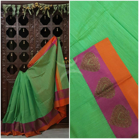 Green Mercerized cotton saree with satin finish contrasting pink and orange pallu and border. Border comes with antique zari motifs.