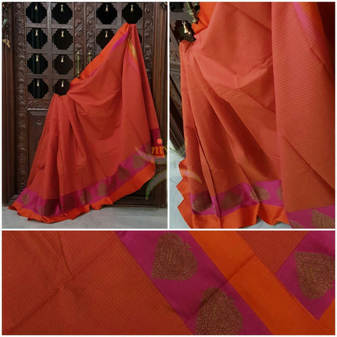 Orange Mercerized cotton saree with satin finish contrasting pink and orange pallu and border. Border comes with antique zari motifs.