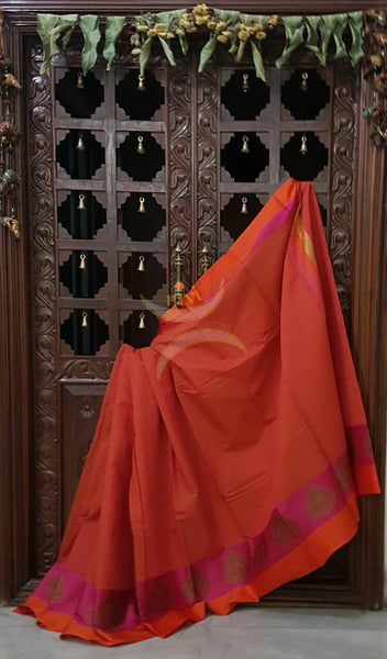 Orange Mercerized cotton saree with satin finish contrasting pink and orange pallu and border. Border comes with antique zari motifs.