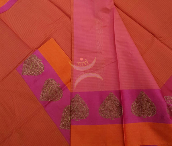 Orange Mercerized cotton saree with satin finish contrasting pink and orange pallu and border. Border comes with antique zari motifs.