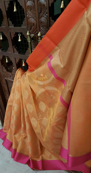 Peach shot Orange Silk Cotton Benaras Brocade Supernet saree with satin finish contrasting pink orange border and antique woven gold zari all over the saree.