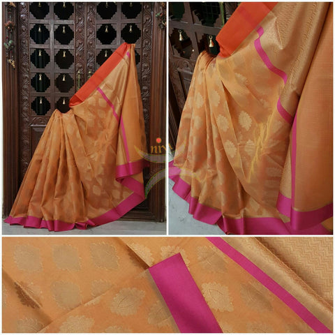 Peach shot Orange Silk Cotton Benaras Brocade Supernet saree with satin finish contrasting pink orange border and antique woven gold zari all over the saree.