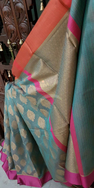 Teal Silk Cotton Benaras Brocade Supernet saree with satin finish contrasting pink orange border and antique woven gold zari all over the saree.