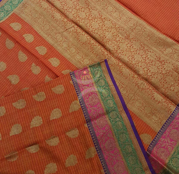 Orange Silk Cotton Benaras Brocade saree with antique zari weaving all over the saree.