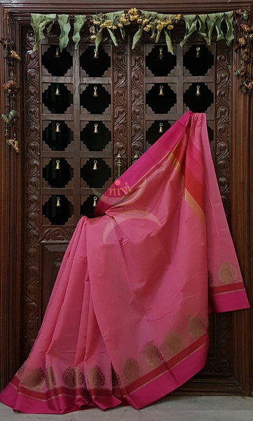 Soft Pink Mercerized cotton saree with satin finish contrasting pink and orange pallu and border. Border comes with antique zari motifs.
