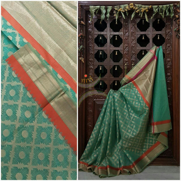 Sea Green Silk Cotton Benaras Brocade saree with contrasting pink orange satin finish lines at border and pallu .Saree is woven with antique gold zari at border ,pallu and all over the saree.