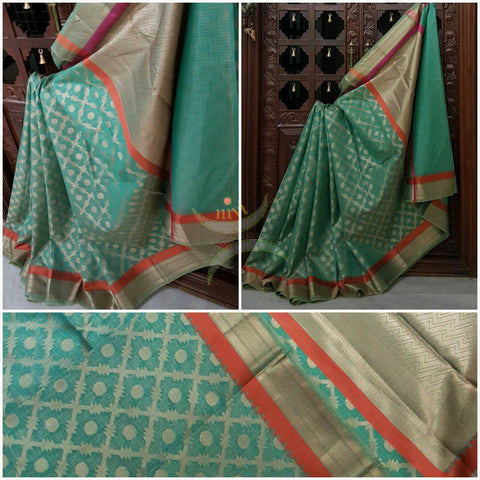 Sea Green Silk Cotton Benaras Brocade saree with contrasting pink orange satin finish lines at border and pallu .Saree is woven with antique gold zari at border ,pallu and all over the saree.