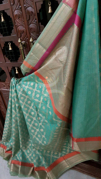 Sea Green Silk Cotton Benaras Brocade saree with contrasting pink orange satin finish lines at border and pallu .Saree is woven with antique gold zari at border ,pallu and all over the saree.