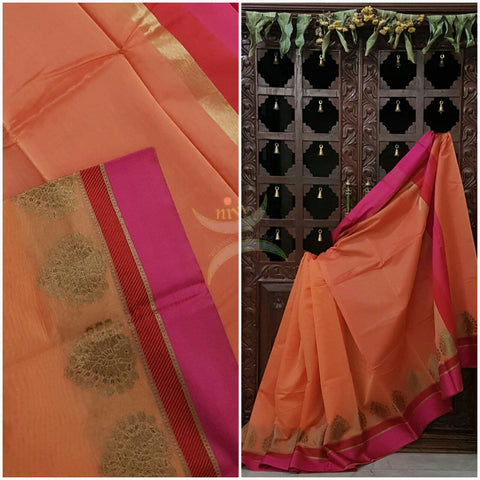 Peach shot Orange Mercerized cotton saree with satin finish contrasting pink and orange pallu and border. Border comes with antique zari motifs.