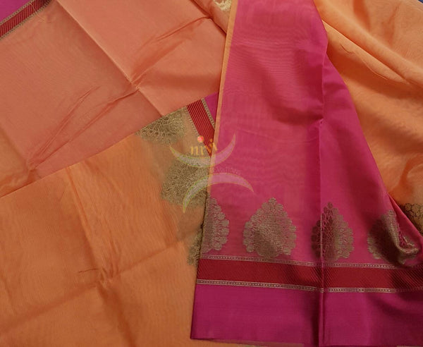 Peach shot Orange Mercerized cotton saree with satin finish contrasting pink and orange pallu and border. Border comes with antique zari motifs.