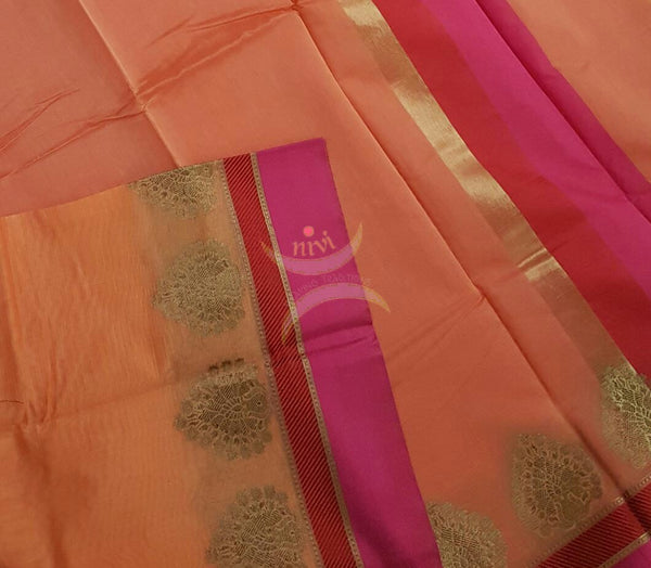 Peach shot Orange Mercerized cotton saree with satin finish contrasting pink and orange pallu and border. Border comes with antique zari motifs.