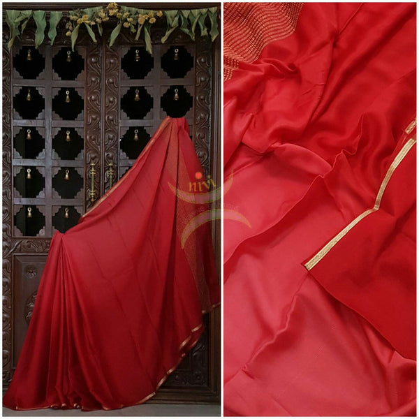 Red 40 gms Two Tone pure Silk Crepe with a fine zari border. Saree comes with pure red crepe blouse in darker tone.