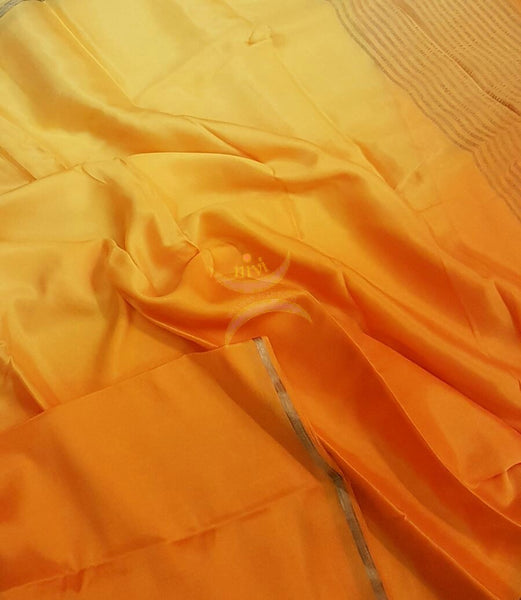 40 gms Two Tone pure Silk Crepe in shades of yellow orange with a fine zari border. Saree comes with pure orange crepe blouse .