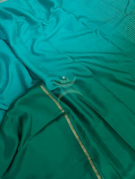 40 gms Two Tone pure Silk Crepe in shades of blue green with a fine zari border. Saree comes with pure Green crepe blouse.