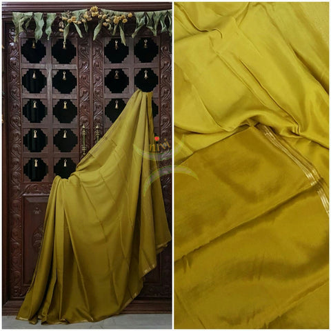 Mehendi Green 40 gms Two Tone pure Silk Crepe with a fine zari border. Saree comes with pure Mehendi Green crepe blouse in darker tone.