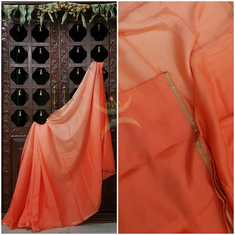 Peach 40 gms Two Tone pure Silk Crepe with a fine zari border. Saree comes with pure peach crepe blouse in darker tone.
