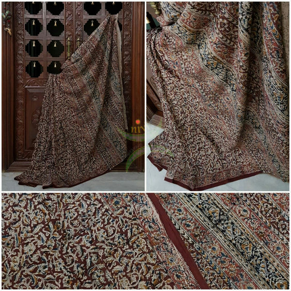 Maroon mul cotton kalamkari with intricate floral motif on the body, border and pallu of the saree.