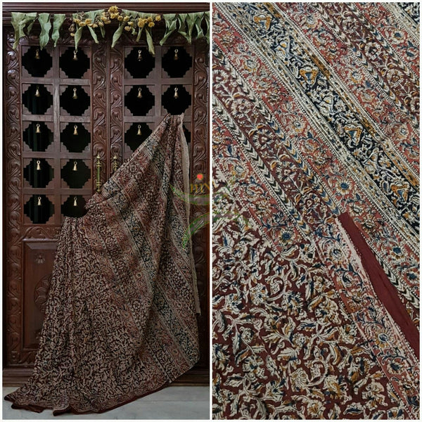 Maroon mul cotton kalamkari with intricate floral motif on the body, border and pallu of the saree.