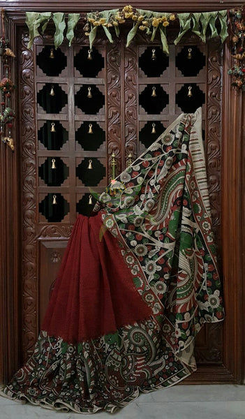 Maroon mul cotton kalamkari with intricate floral and peacock on the border and pallu.