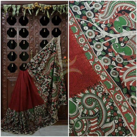 Maroon mul cotton kalamkari with intricate floral and peacock on the border and pallu.