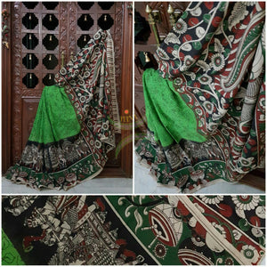 Green mul cotton kalamkari with intricate musical instruments and marriage possession motif on the border and peacock motif on the pallu.