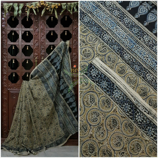 Green mul cotton kalamkari with intricate floral motif on the body, border and pallu of the saree.
