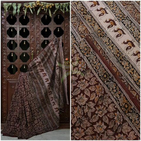 Brown mul cotton kalamkari with intricate floral motif allover the saree .