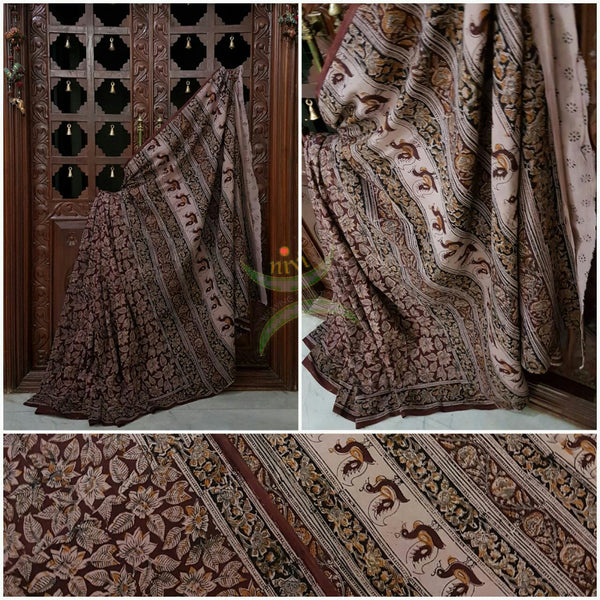 Brown mul cotton kalamkari with intricate floral motif allover the saree .