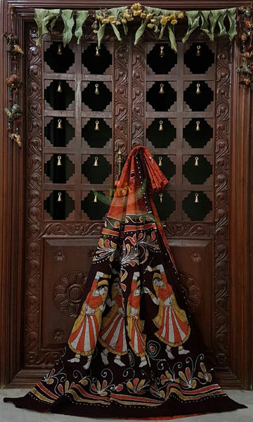Rust orange brown handloom Mul Cotton Batik saree with human figure motif on contrasting Brown border and pallu