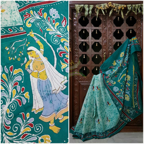 Sea green off white handloom Mul Cotton Batik saree with human figure motif on contrasting teal border and pallu