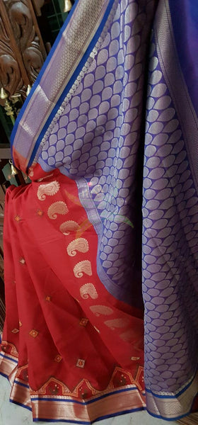 Red with blue kota cotton saree with kasuti embroidery. Saree is woven with Paisley motif and Brocade border and pallu.