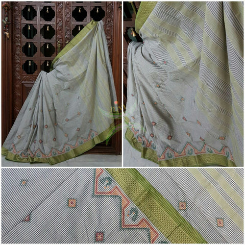 Grey kota Cotton chequered saree with kasuti embroidery. Saree is woven with contrasting zari border.