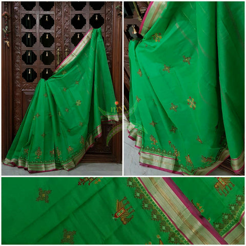 Green with pink kota Cotton saree with kasuti embroidery. Saree is woven with contrasting border and striped pallu.
