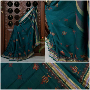 Teal Kota cotton saree with kasuti embroidery. Saree is woven with zari border and striped pallu.