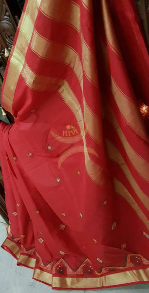 Red Kota cotton saree with kasuti embroidery. Saree is woven with tissue border and striped pallu.