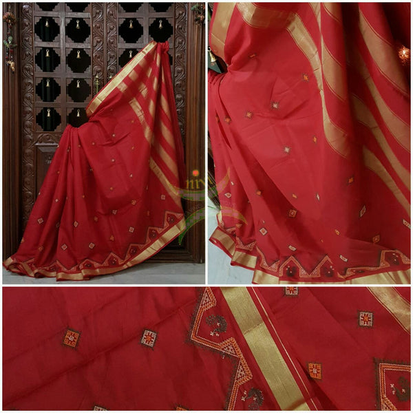 Red Kota cotton saree with kasuti embroidery. Saree is woven with tissue border and striped pallu.
