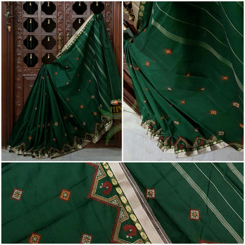 Bottle green Kota cotton saree with kasuti embroidery. Saree is woven with tissue border and striped pallu.