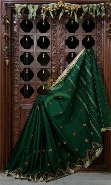 Bottle green Kota cotton saree with kasuti embroidery. Saree is woven with tissue border and striped pallu.