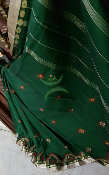 Bottle green Kota cotton saree with kasuti embroidery. Saree is woven with tissue border and striped pallu.