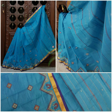 Bottle green Kota cotton saree with kasuti embroidery. Saree is woven with zari border and striped pallu.